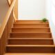 Wooden staircase with small potted plants on each step representing step by step progress