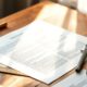 Printed pages, ruler, compass, and outline showing how to structure a how‑to article for readers