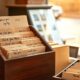 Small shop counter with loyalty cards and index file illustrating best CRM for tracking customer retention metrics for small business